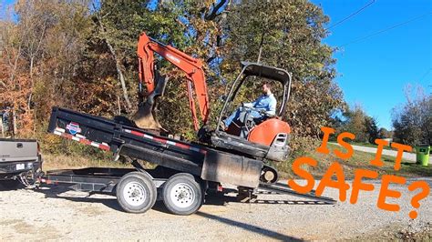 hauling mini excavator in dump trailer|dump trailer loading.